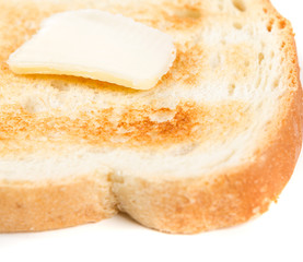 Toasted whole grain bread with a pat of butter isolated on white background