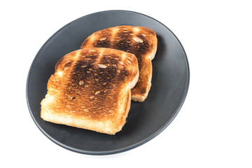 Burned whole grain toast isolated on white background
