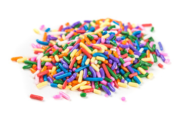 Assorted rainbow colored sprinkles isolated on white background