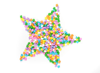 Star shaped assorted rainbow colored sprinkles isolated on white background
