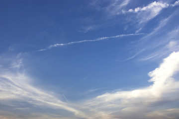 Fototapeta premium The long line of Jet engine cloud on beautiful blue sky.