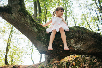 girl sitting on a tree. foot. Feet