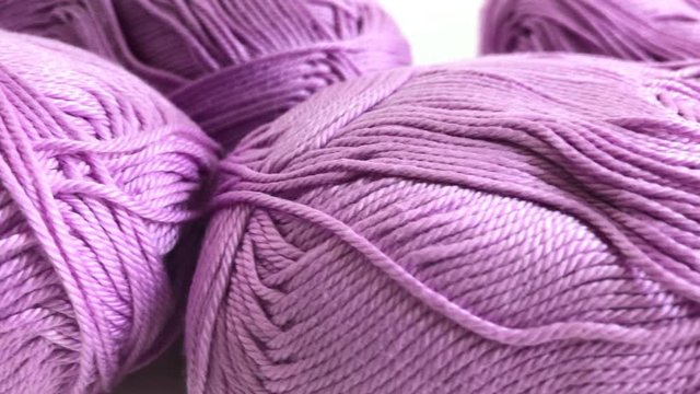 Shallow DOF pink yarn of wool wrapped in loose twist 4K 2160p 30fps UltraHD footage - Pink skeins of knitting wool dolly 3840X2160 UHD video