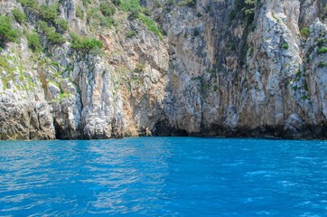 Sea cave entrance view from a deep blue sea