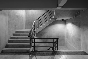 Empty modern rough concrete stairway with black steel handrail - obrazy, fototapety, plakaty