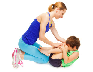 Naklejka premium Mother teaching her kid son making gymnastics