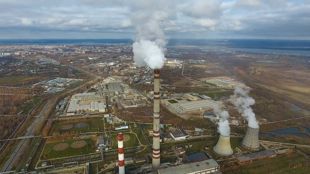 Aerial flying over dirty exhaust area. Heavy industry factories area, smoke from chimneys. 4K.