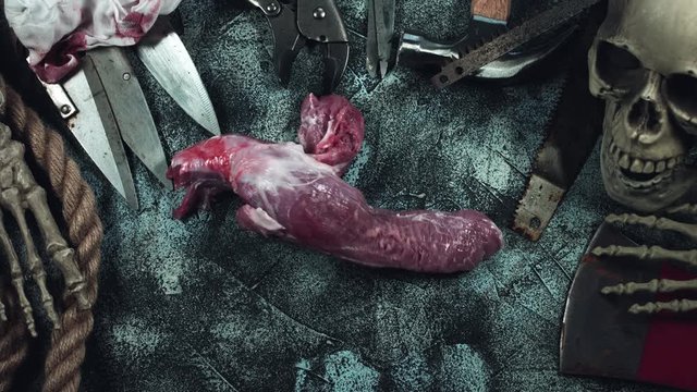 4k Horror and Bloody Composition of a Cannibal Throwing  Raw Meat
