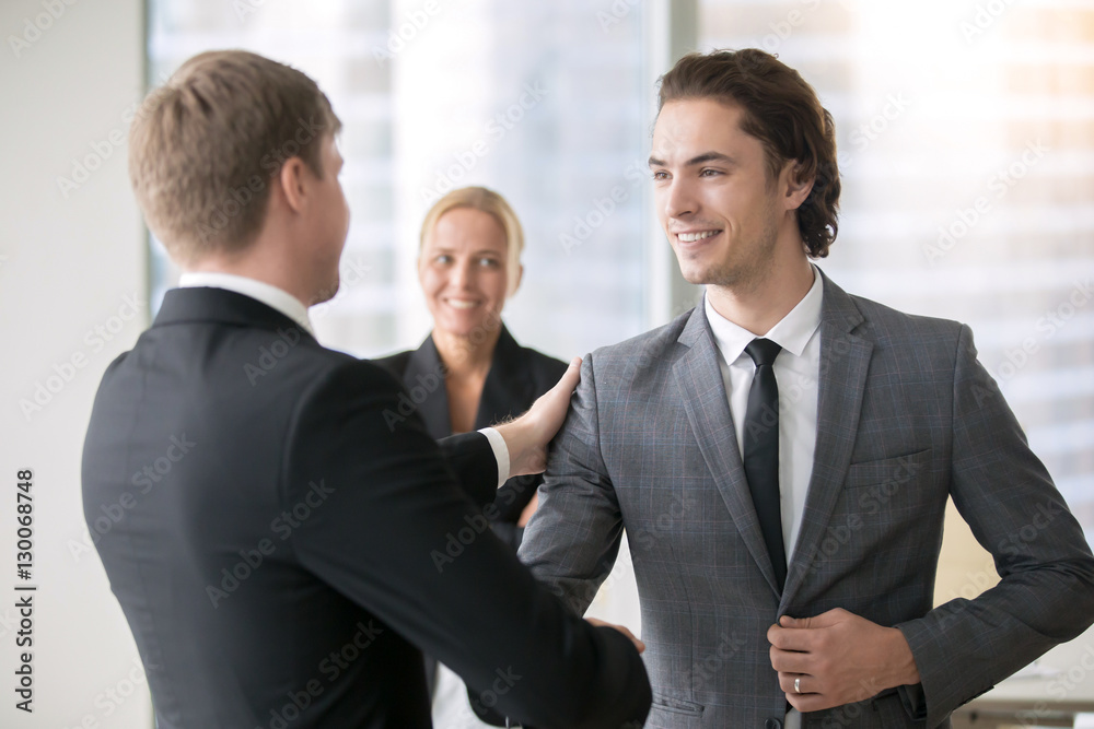 Wall mural two smiling businessmen handshaking