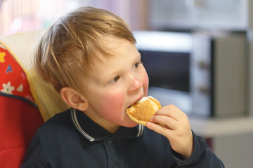 emotions three year old boy at the table during the meal