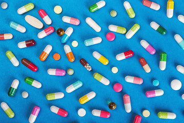 pills and tablets of different colors background. little depth of field, soft focus