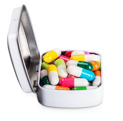many different colored pills isolated on white background 