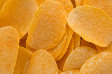 Close up potato chips on wood top view background.