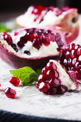 Red sweet pomegranate on the wooden table