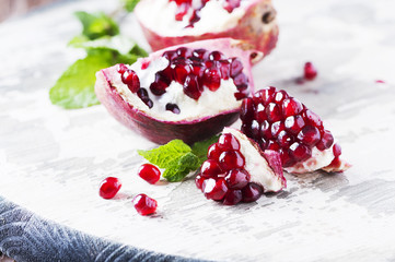 Red sweet pomegranate on the wooden table