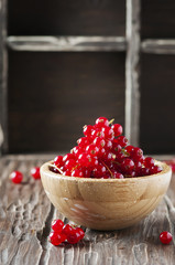 Macro photo of red currant on the wooden table