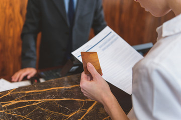 Woman going to pay for room in hotel