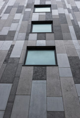 Obraz premium Looking up at windows of modern concrete office building