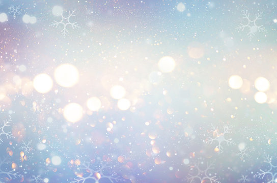 Christmas glow winter background. Defocused snow background with blinking stars and snowflakes