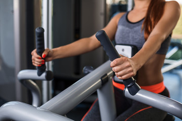 Photo of woman doing exercises on the simulator