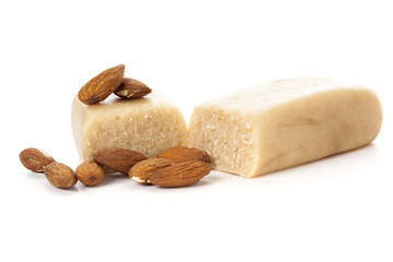 Marzipan bar and almonds isolated on white background