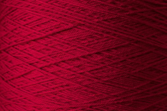 Red Yarn Threads close up macro shot background texture 