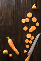 sliced carrot on  slate and wooden counter top background