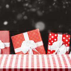 Obraz premium Fabric tabletop with red christmas gift box set for product mont