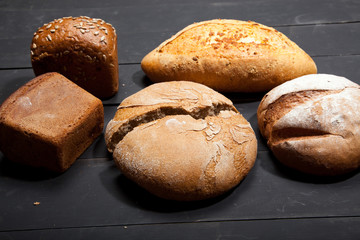 Homemade bread on a black wooden background