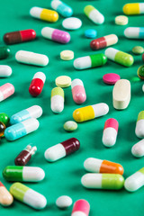 pills and tablets of different green background