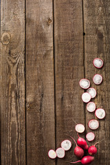 sliced radish on slate and wooden counter top background