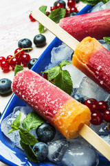 homemade popsicles with red currants and blueberries 