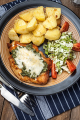 Fried chicken fillet with spinach and cheese.