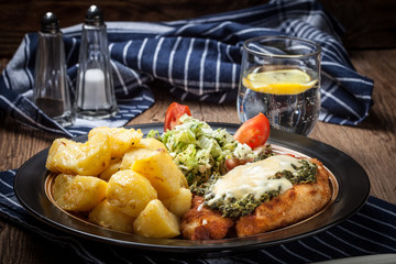 Fried chicken fillet with spinach and cheese.