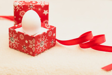 Happy new year / Marry Christmas White egg in red box on white background and red ribbon reminds heart