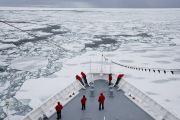 Ship breaking through ice floe and drift ice, Greenland, Arctic