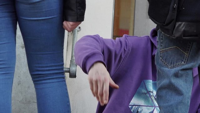 homeless asking charity and talking with young people