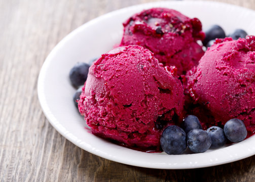 blueberry ice cream scoops with fresh berries