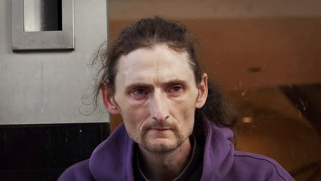 homeless closeup portrait: jobless, hopeless, drugs addicted in the street