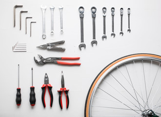 Bicycle fixing tool kit. Flat lay of work tools and bicycle wheel