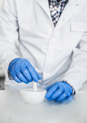 Chemist performs an experiment with liquid nitrogen