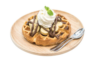 breakfast dessert, waffle with banana chocolate and whip cream topping.