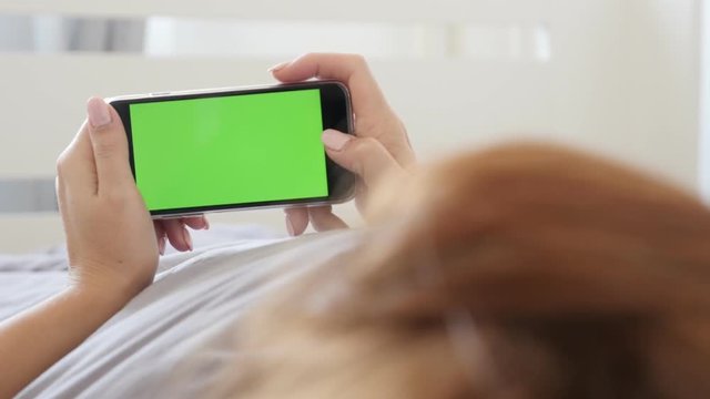Green screen phone in female hands 4K 2160p 30fps UltraHD footage - In bedroom woman holds greenscreen display tablet computer 3840X2160 UHD video 
