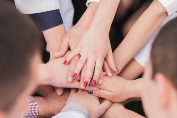 Hands of young people in the nature