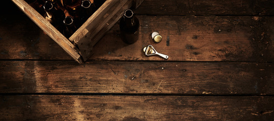 Beer bottles in a crate in a rustic pub or tavern