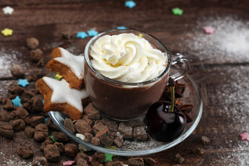 Hot chocolate cocoa with whipped cream on vintage wooden background, selective focus