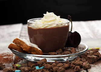 Hot chocolate cocoa with whipped cream on vintage wooden background, selective focus