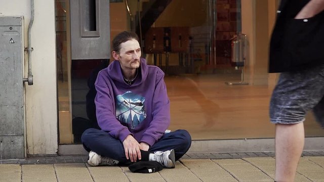 homeless waiting for people giving change, coins, charity