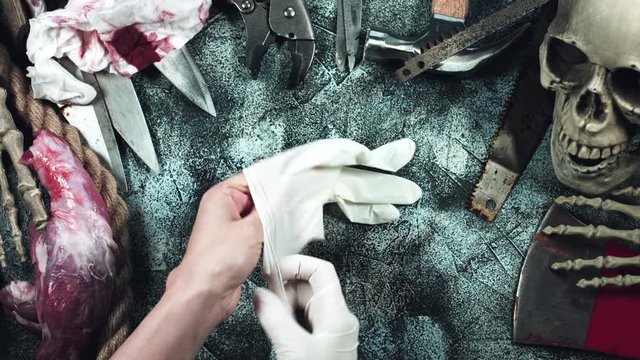 4k Horror and Bloody Composition of Hands putting on Latex Glove