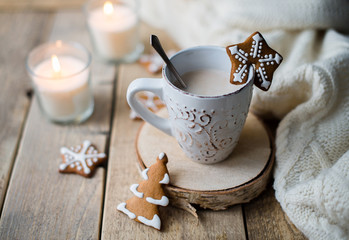Fototapeta na wymiar Cup of hot chocolate with gingerbread and candle.